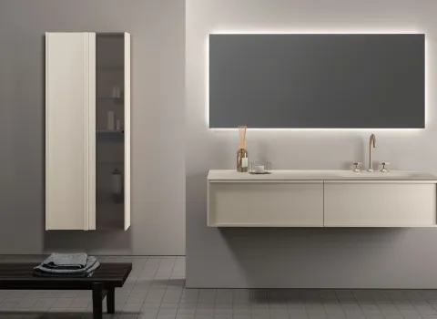 Puristisches Badezimmer von Stocco mit cremefarbenem Doppelwaschtisch, goldener Armatur und großem, hinterleuchtetem Spiegel.